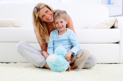 Woman with her son sitting on new carpet