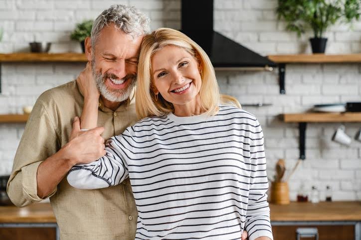 Couple smiling near a UV air purifier