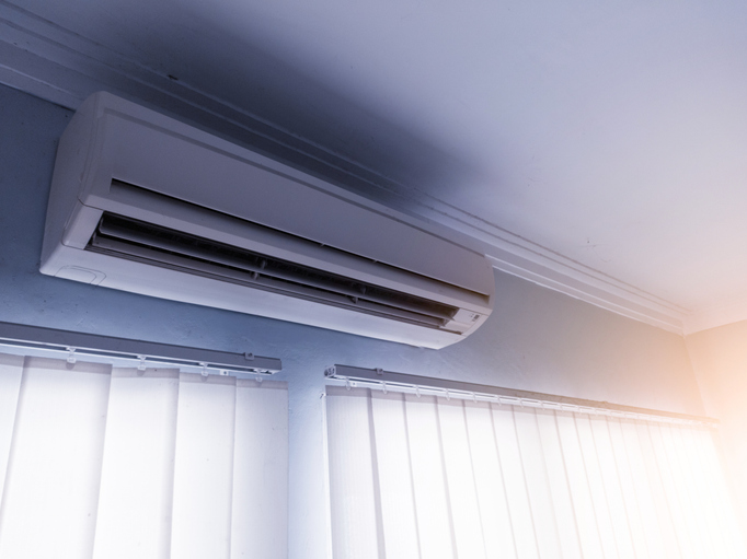 Wall-mounted ductless air conditioner unit in a modern room.